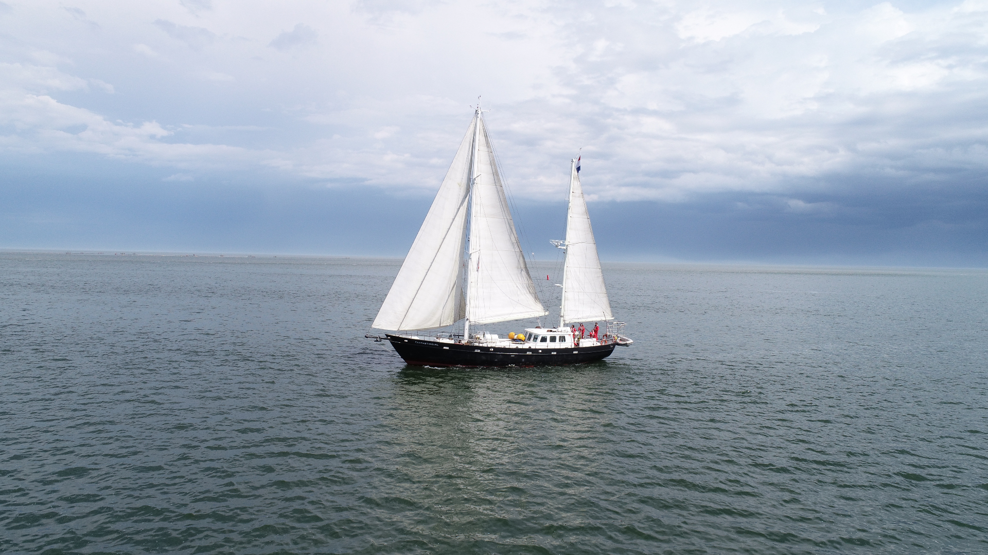 Tweemastzeilschip op het IJsselmeer, vastgelegd vanuit de lucht